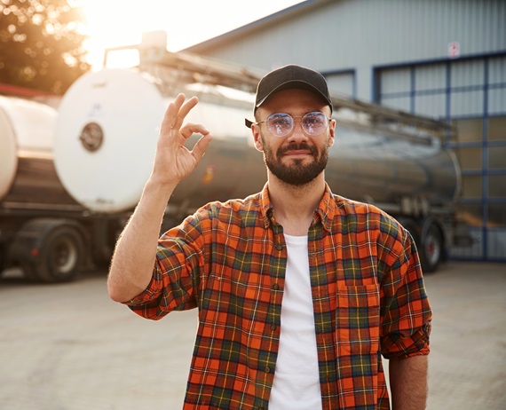 Front view. Young truck driver in casual clothes