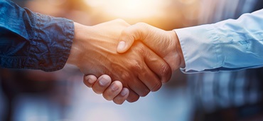 Insurance agent shaking hands with a client, agreement and trust, successful deal