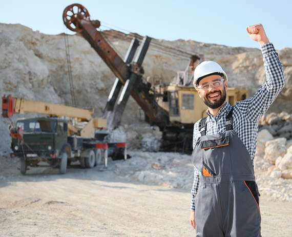 Male worker with bulldozer in sand quarry